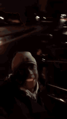 a man wearing a hat and a hoodie is making a funny face