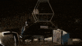 a blurry picture of a person standing in a dark room .