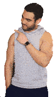 a man with a beard wearing a grey tank top and a smart watch