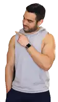 a man with a beard wearing a grey tank top and a smart watch