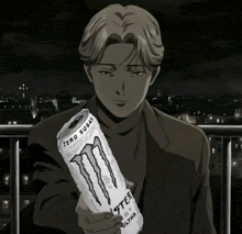 a man in a suit holds a can of monster energy drink