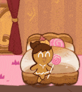 a gingerbread girl is sitting on a bed with a lollipop