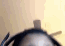 a close up of a person 's face wearing headphones and a hat .