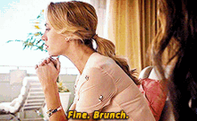 a woman is sitting on a couch and saying fine brunch