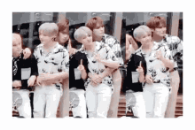 a group of young men are standing next to each other giving thumbs up .