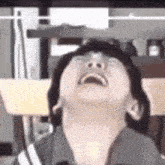 a close up of a person laughing with their eyes closed