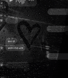 a black and white photo of a heart drawn on a glass