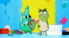 two cartoon characters are standing next to each other in front of a wall covered in paint .