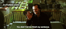 a man is standing on a balcony with his hands up and says you didn 't let me finish my sentence .
