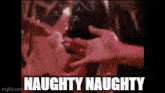 a man is touching a woman 's breast in a video with the words naughty naughty written below him .