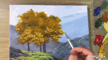 a person is painting trees on a canvas with a made in animatica logo