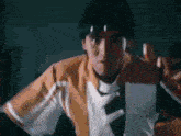 a man is holding a piece of paper in his hand and wearing a headband .