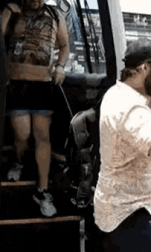 a man standing next to a woman walking down stairs .