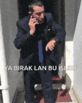 a man in a suit and tie talking on a cell phone