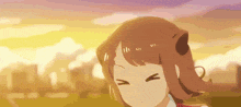 a close up of a girl 's face with a sunset in the background