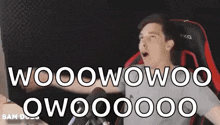 a man is sitting in a chair with his mouth open and the words wooowooo qwo00000 written on the screen .