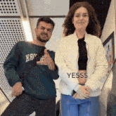 a man and a woman standing next to each other with the word yesss on the bottom left