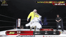 a woman in a yellow jacket and white dress is dancing in a ring with a stardom logo on the bottom