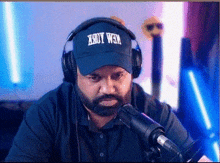 a man with a beard wearing headphones and a blue hat that says 190y wem