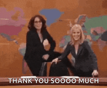 two women are dancing in front of a wall with the words `` thank you sooo much '' .