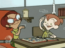 a cartoon of a boy and a girl sitting at a desk looking at a book .