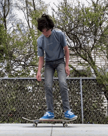 a person standing on a skateboard with a t-shirt that says ' skateboarder ' on it