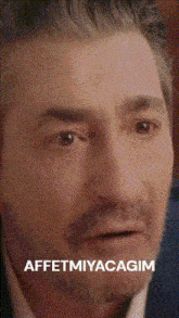 a close up of a man 's face with the words affetmiyacagim written below it