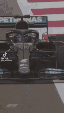 a close up of a race car with the word petronas on it