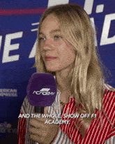 a woman is holding a microphone that says academy