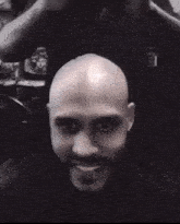 a man with a beard is getting his hair cut
