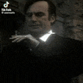 a man in a suit and tie has a tiktok sticker on his chest