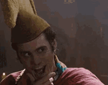 a man wearing a hat and a pink jacket is saying no
