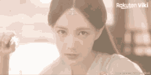a close up of a woman 's face with a rakuten viki logo in the corner
