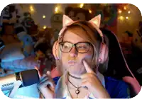 a woman wearing pink headphones with cat ears is pointing at her face