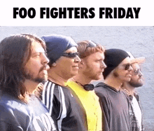 a group of men standing next to each other in a row with the words foo fighters friday written above them .