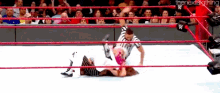 a wrestling match is going on in front of a crowd and the words the next big thing can be seen in the corner