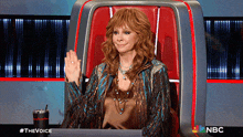 a woman sitting in a chair with the word nbc on the bottom right