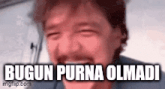 a man with a mustache is laughing with the words `` bugun purna olmadi '' written on his face .