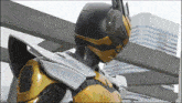 a man in a bee costume is standing in front of buildings