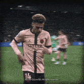 a soccer player wearing a qatar airlines shirt