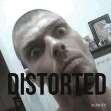a man with a piercing in his nose is looking at the camera with the word distorted behind him