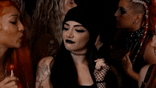 a woman with a tattoo on her shoulder is smiling in a crowd of people