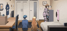 a girl in a striped pajama is standing in a room with two other girls