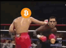 a man in a boxing ring has a coin with a b on it