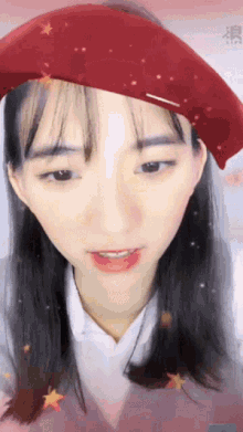 a woman wearing a red beret and a white shirt