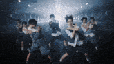 a group of people in school uniforms are dancing on a street