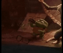 a turtle is holding a gun in a room with a person standing next to it .