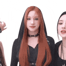 a woman with red hair is wearing a black top