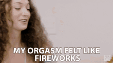 a woman with curly hair is talking about her orgasm .