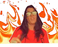 a woman wearing glasses and a red shirt stands in front of a flaming background